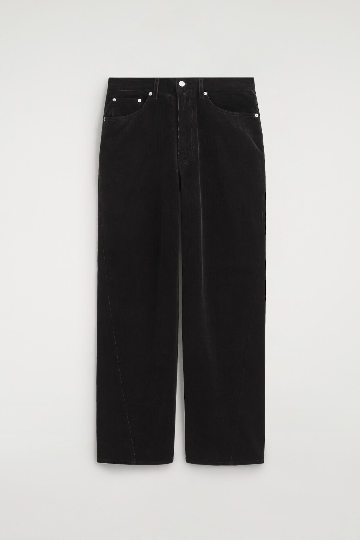 These black Facade corduroy straight-leg jeans are shown from the front, highlighting their textured ribbed fabric, classic five-pocket construction and silver-tone button fastening. The straight-leg silhouette is accented by distinctive diagonal seams that curve inwards towards the front hem.
