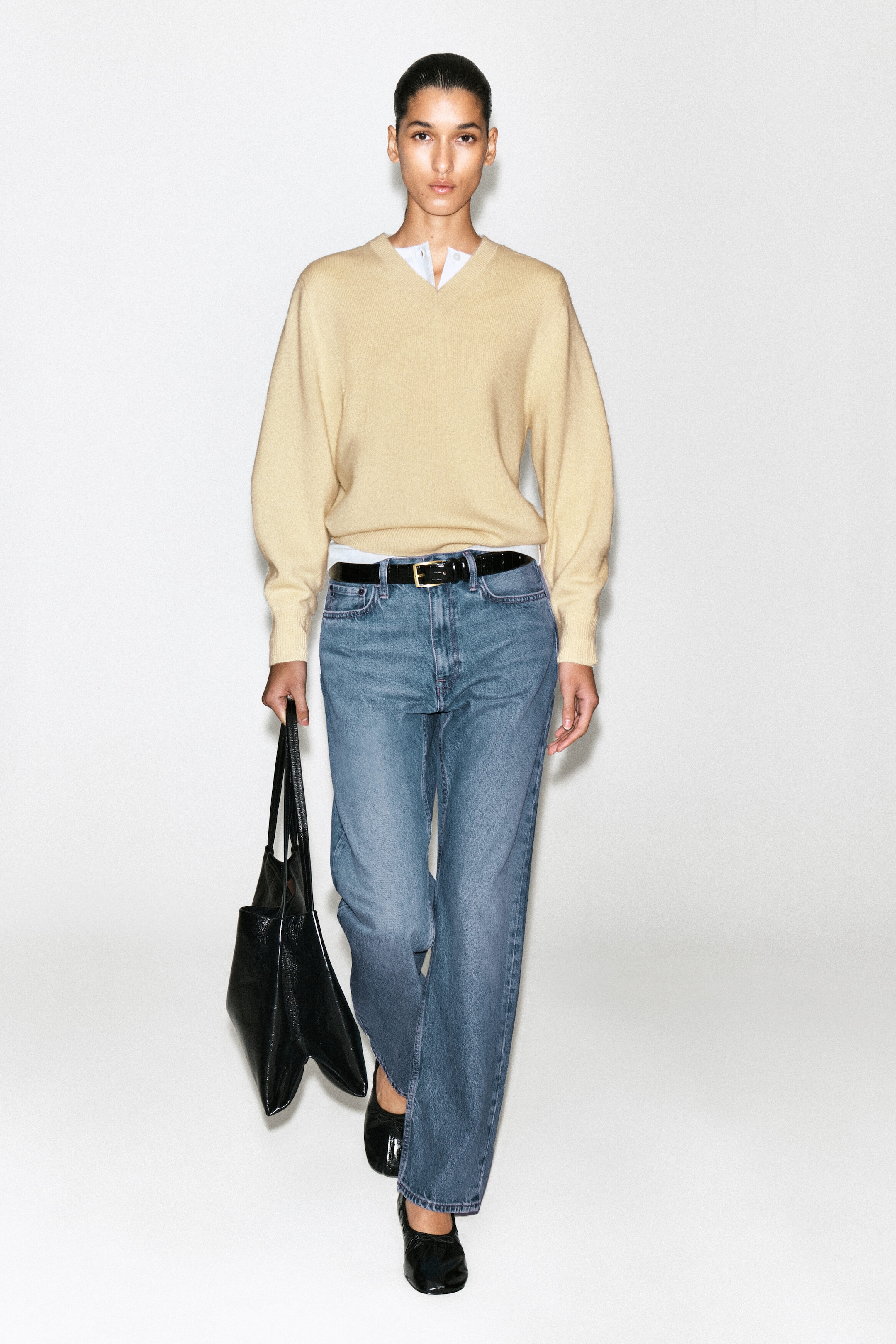 The Chord Straight Leg Jeans are shown from the front, featuring a medium-blue wash and a relaxed, straight-leg silhouette. They sit at the waist and are styled with a black leather belt with a gold buckle. The Chord Straight Leg Jeans are shown from the front, featuring a medium-blue wash and a relaxed, straight-leg silhouette. They sit at the waist and are styled with a black leather belt with a gold buckle.