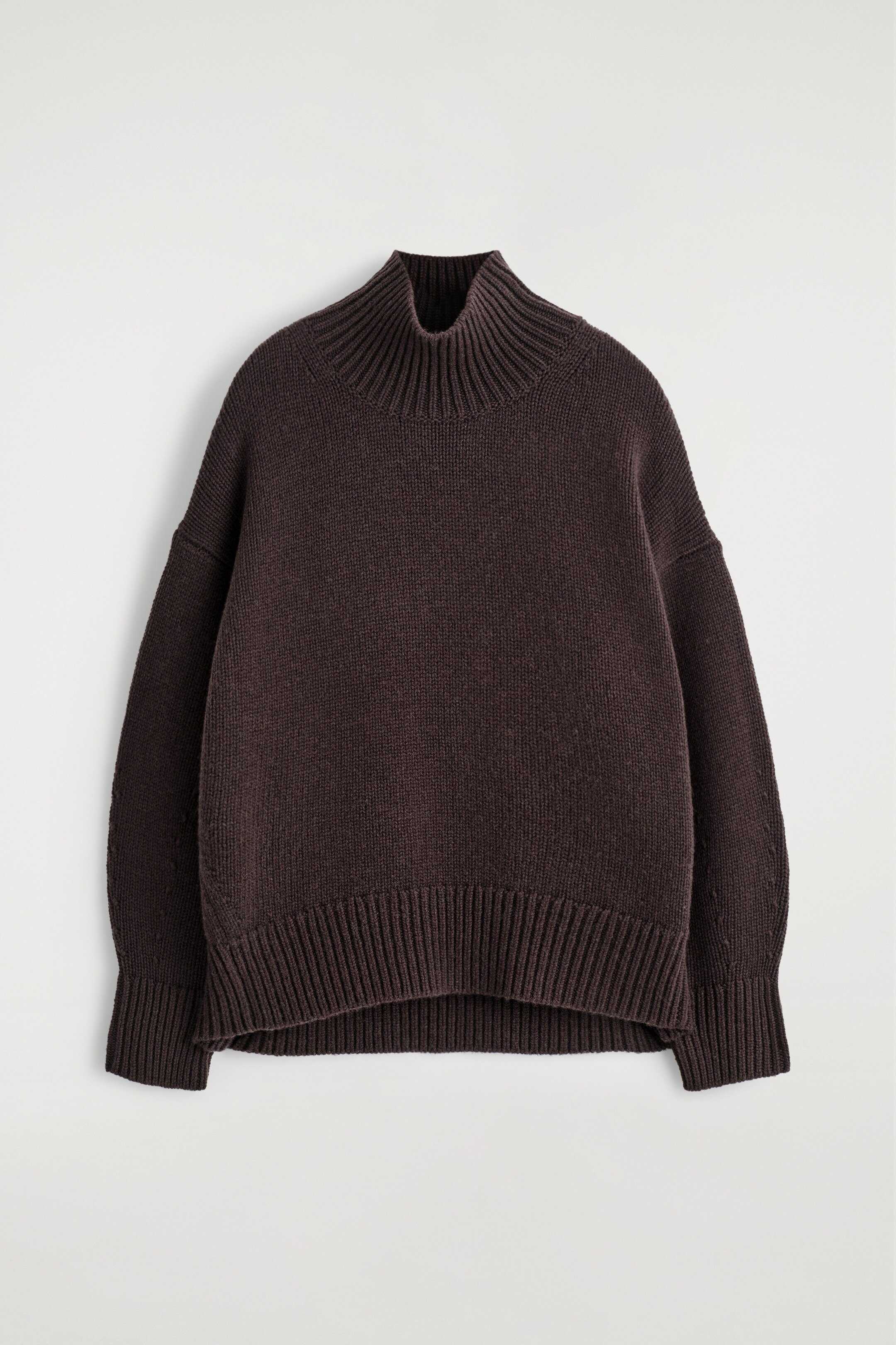 View larger image: A cappuccino-hued jumper is presenting FRONT, featuring a plain knitted body with a chunky ribbed funnel neck. It has dropped shoulders, wide sleeves ending in ribbed cuffs, and a wide ribbed hem, all contributing to its relaxed fit.