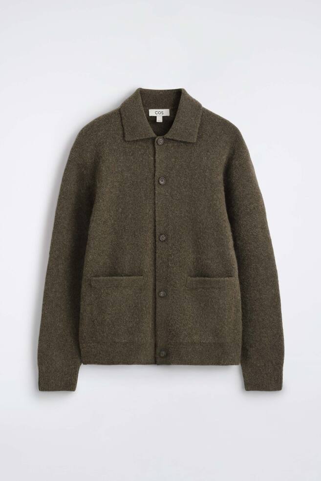 A textured collared cardigan is facing front, showcasing a soft, fuzzy knit in a dark olive green hue. It features a spread collar, a five-button front fastening, two front welt pockets, and ribbed cuffs. - 1