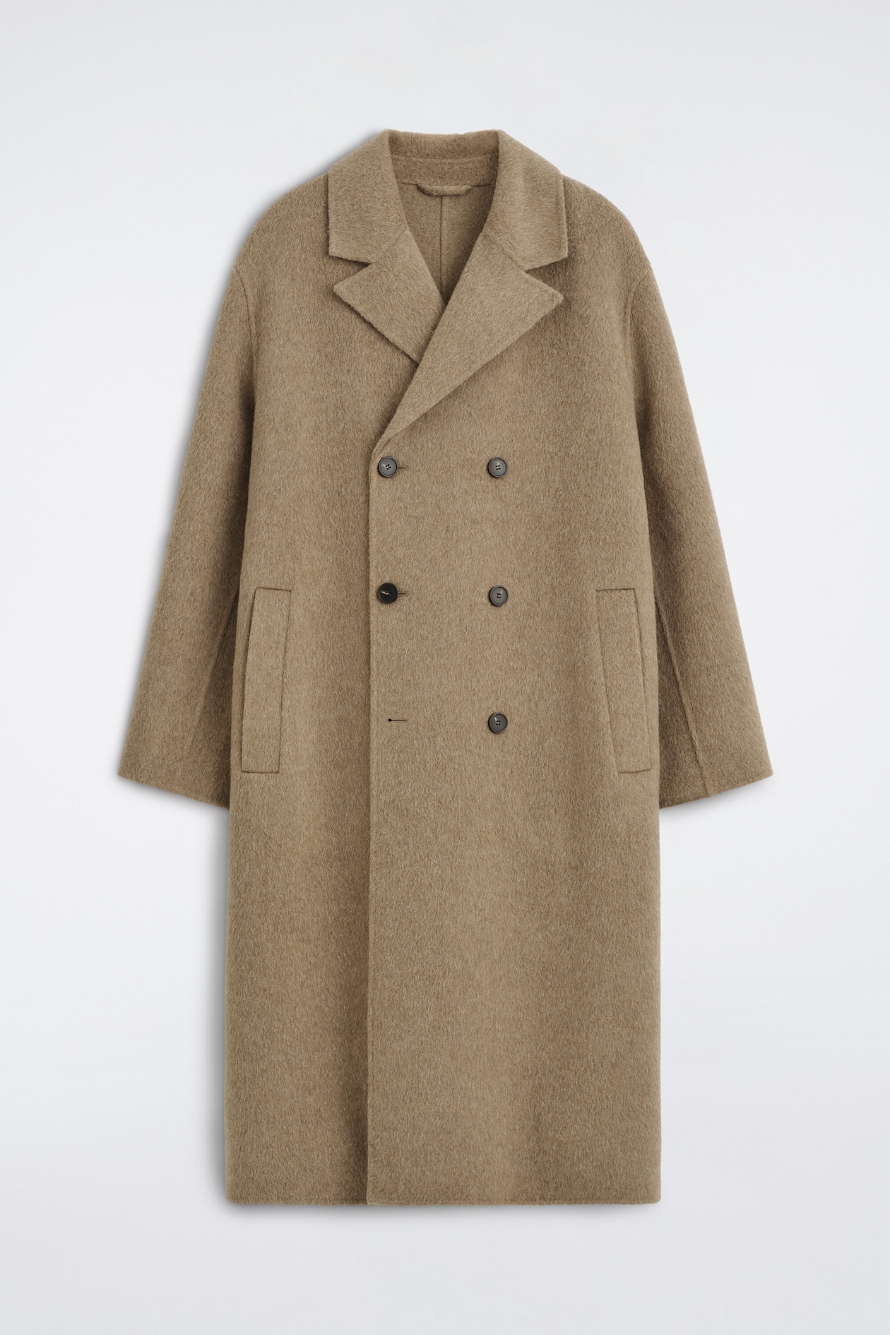 A double-faced wool-blend long coat is shown from the front, featuring a double-breasted button closure, wide notch lapels, and vertical welt pockets. The coat has a relaxed, straight silhouette with long sleeves in a textured taupe-brown fabric.