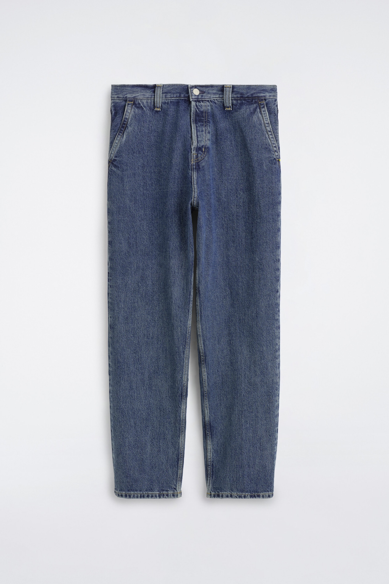 These relaxed-fit straight-leg denim trousers are hanging in a front-facing view, showcasing a medium-blue wash with subtle fading. The design features a classic waistband with belt loops, a central button fastening, and angled front pockets.