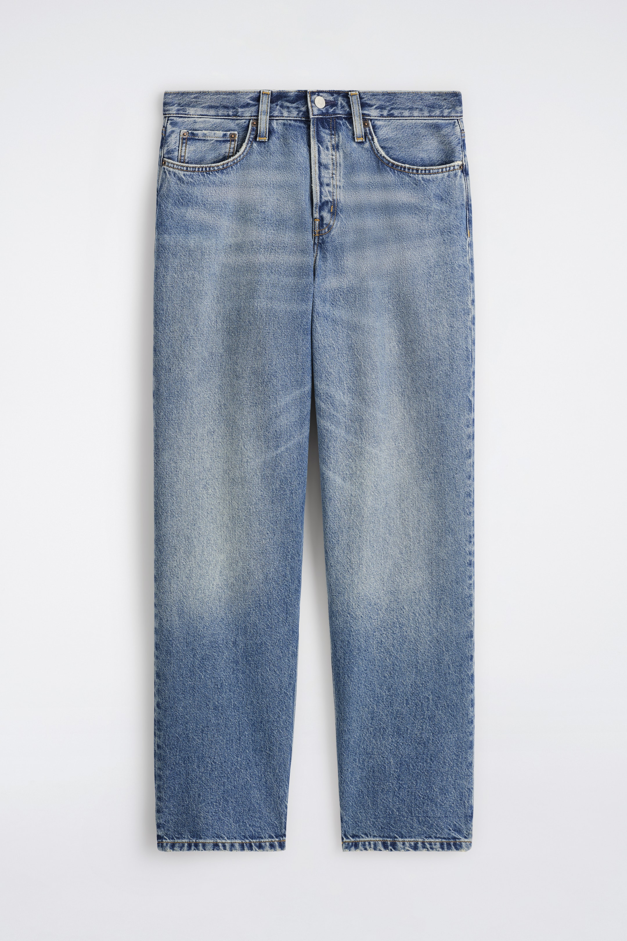 Visa större bild: Framsidan av ett par blå denimjeans visas, med en blekt tvätt som har ljusare områden på låren och mörkare fållar. Dessa jeans med raka ben är designade med en knappstängning, bältesöglor och två främre scoopfickor inklusive en myntficka.