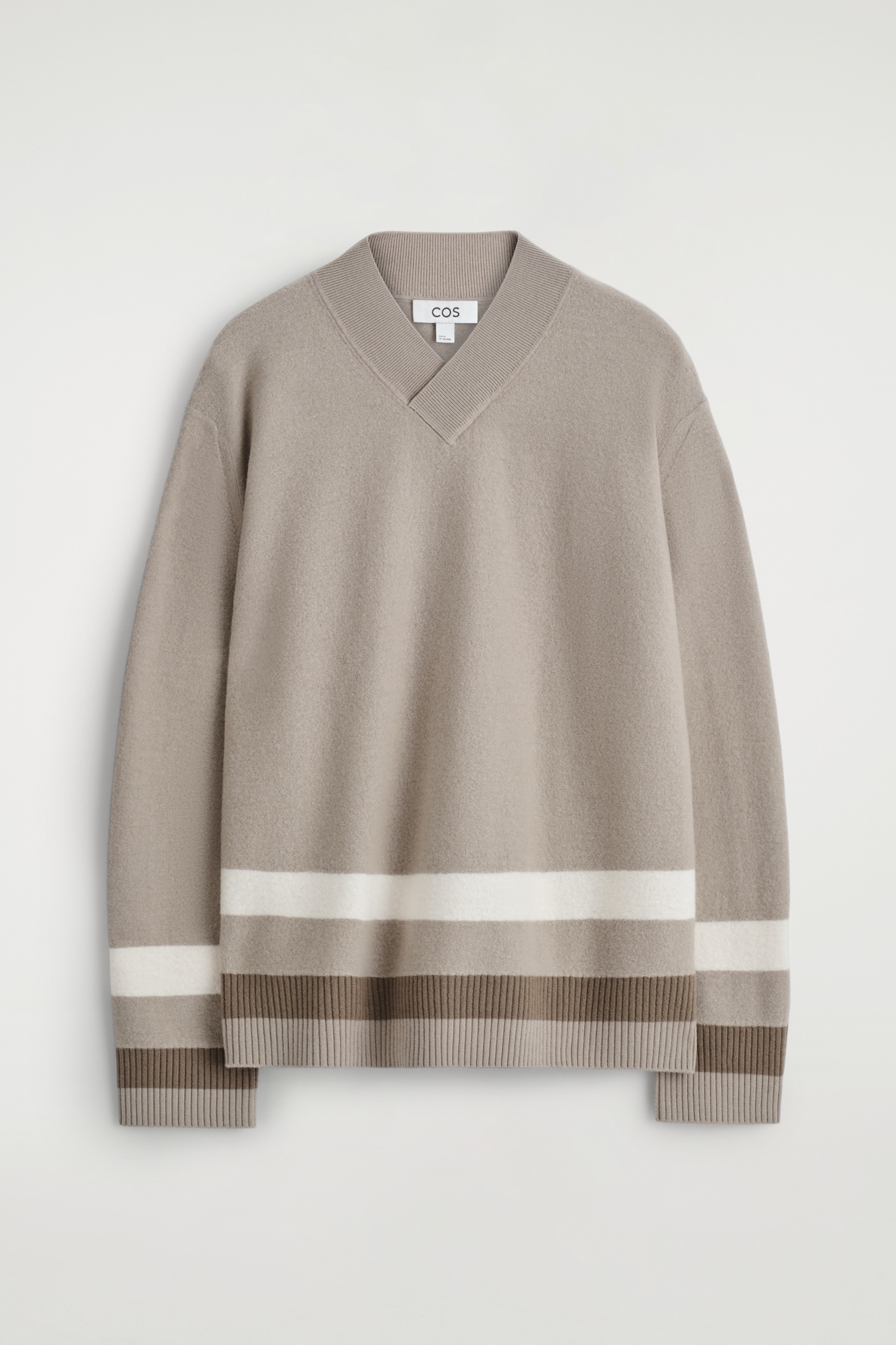 View larger image: A light brown sweater is presented from the FRONT, featuring a ribbed V-neck collar. It is displaying a wide white horizontal stripe above the bottom hem and on the lower sleeves, with two narrower brown stripes forming the ribbed hem and ribbed cuffs.