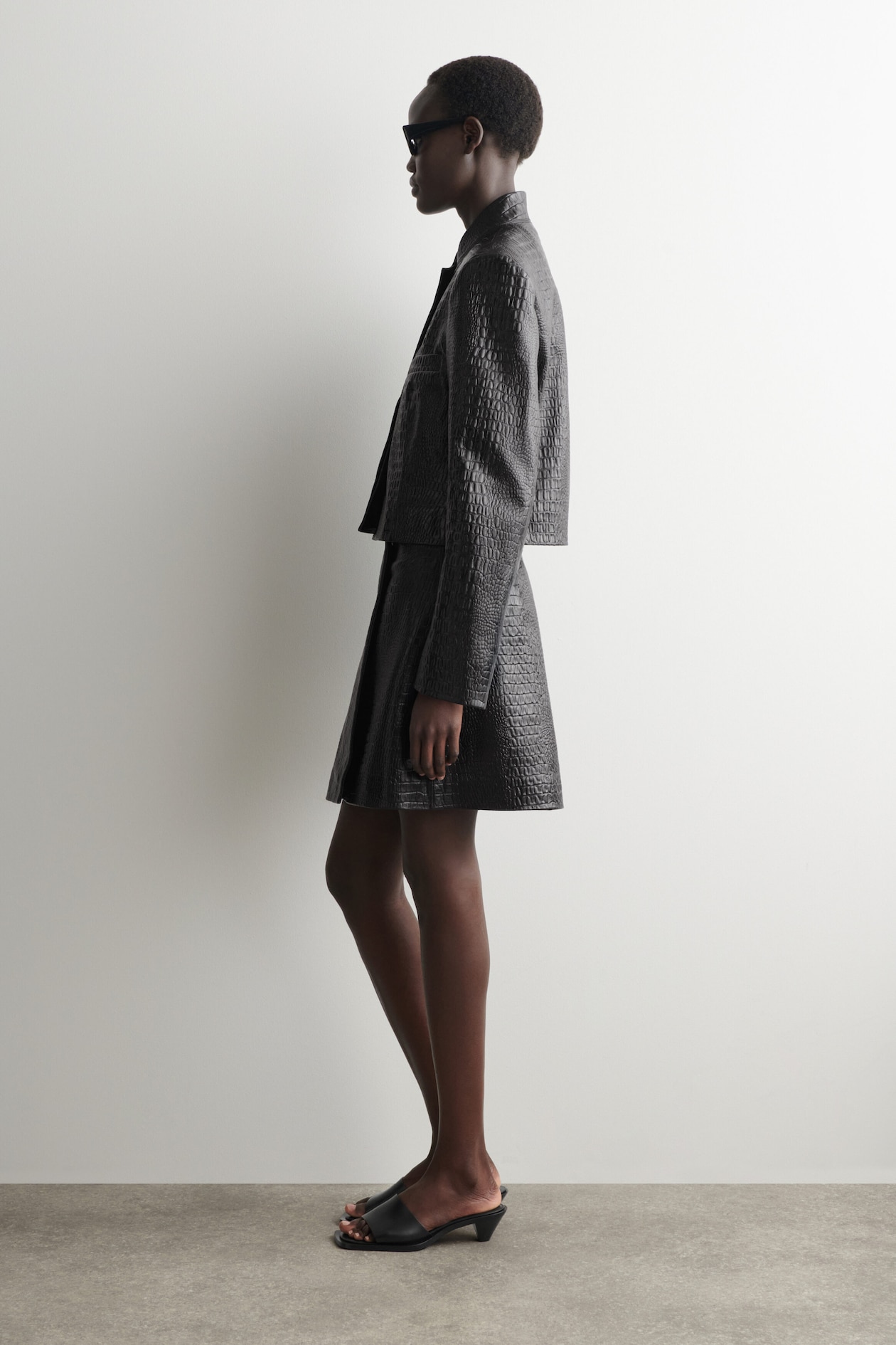 CROC-EFFECT LEATHER MINI WRAP SKIRT — BLACK