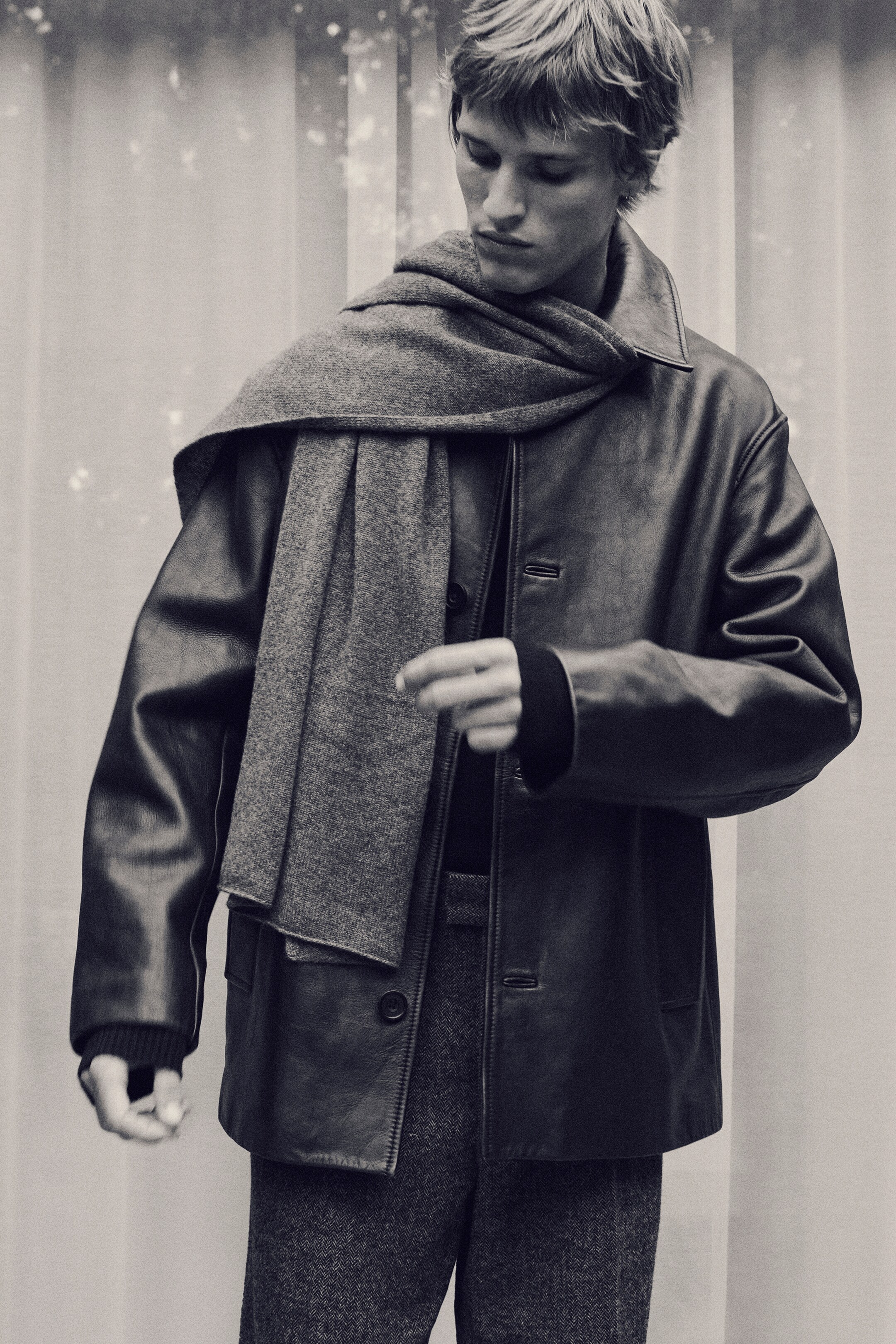 View larger image: A soft grey scarf is draped around a person's neck, with one end hanging over the front of their jacket.