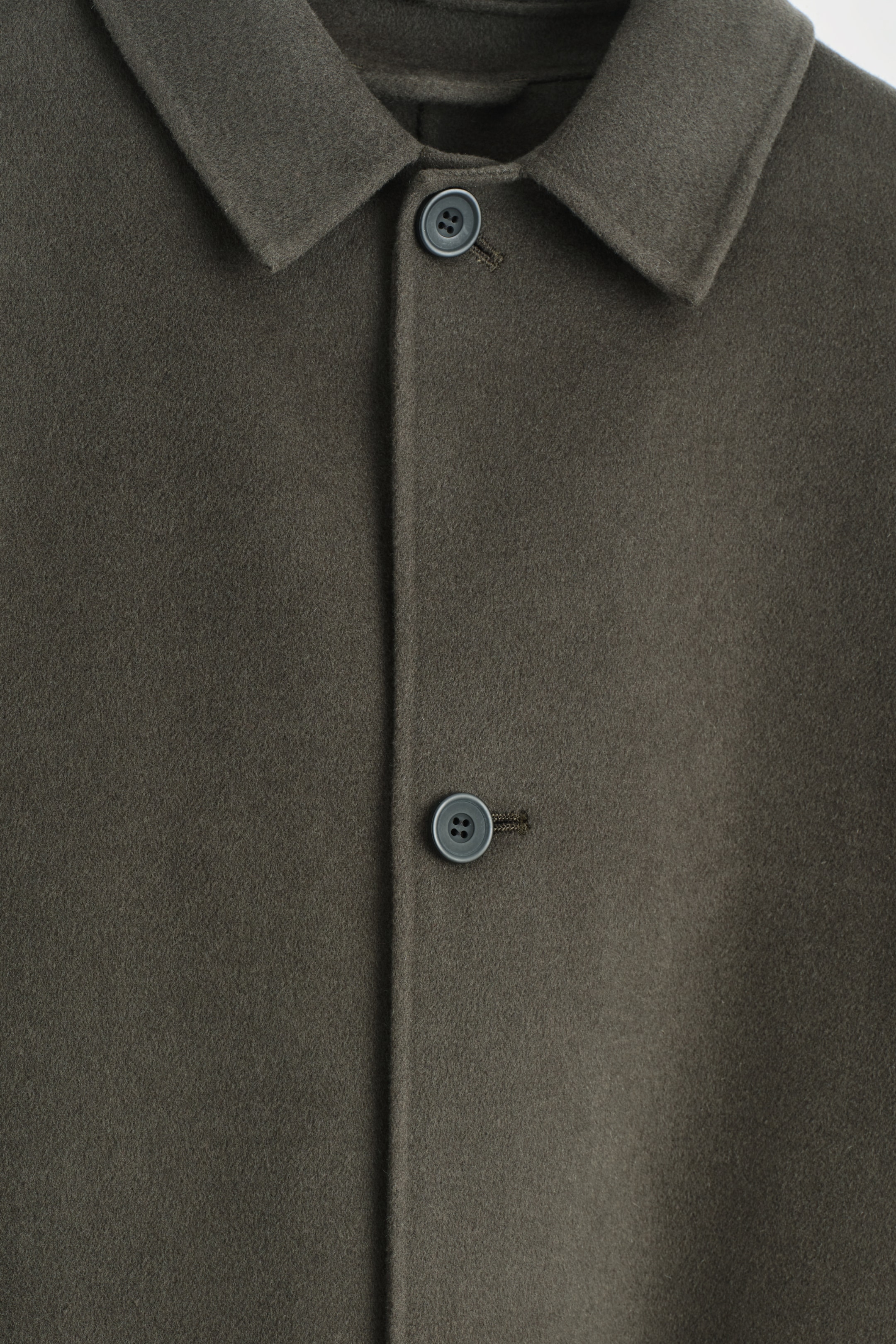 Visualizza immagine più grande: La PARTE ANTERIORE di un cappotto color espresso è visibile, realizzato in un tessuto fine e peloso e caratterizzato da un colletto a punta. Due bottoni grigio scuro chiudono la paramontura anteriore.