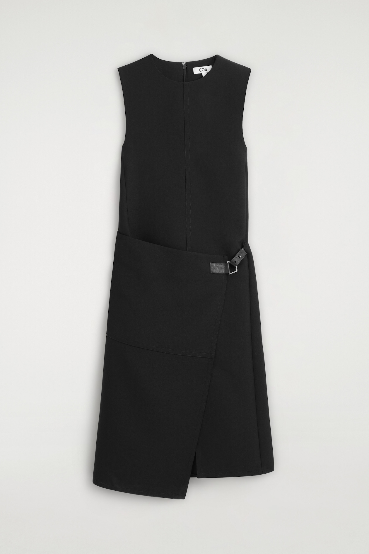 The belt-detail double-faced wool midi dress is shown from the front, featuring a sleeveless silhouette with a round neckline and a central vertical seam. The design showcases an asymmetrical wrap skirt secured at the left hip with a small black leather strap and a silver-tone buckle.