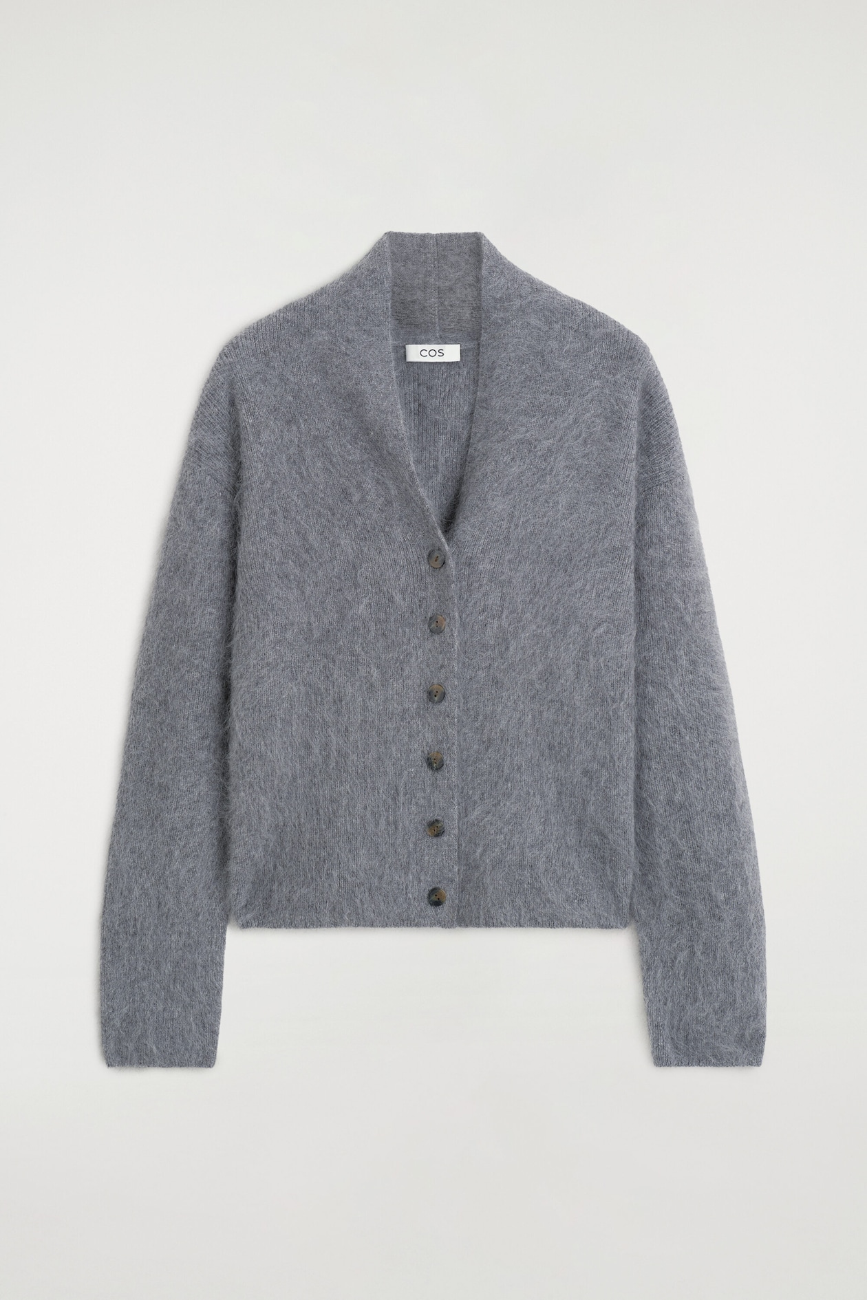This gray draped brushed merino wool cardigan is shown from the front, highlighting its fuzzy, brushed texture and draped shawl collar that creates a V-neckline. The design features a six-button front closure and long sleeves with dropped shoulders.
