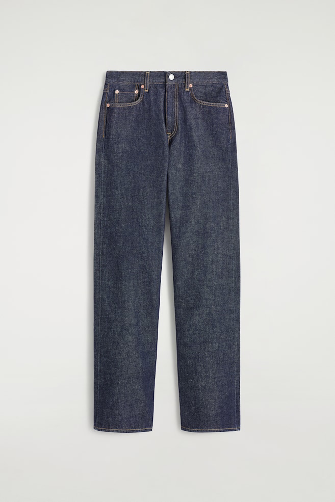 A pair of dark indigo denim jeans is being shown FRONT, featuring a straight-leg cut and a high rise. Tobacco-colored topstitching is detailing the seams and front pockets, which are accented with copper-toned rivets, and a silver-toned button and zip closure are visible at the waistband. - 1