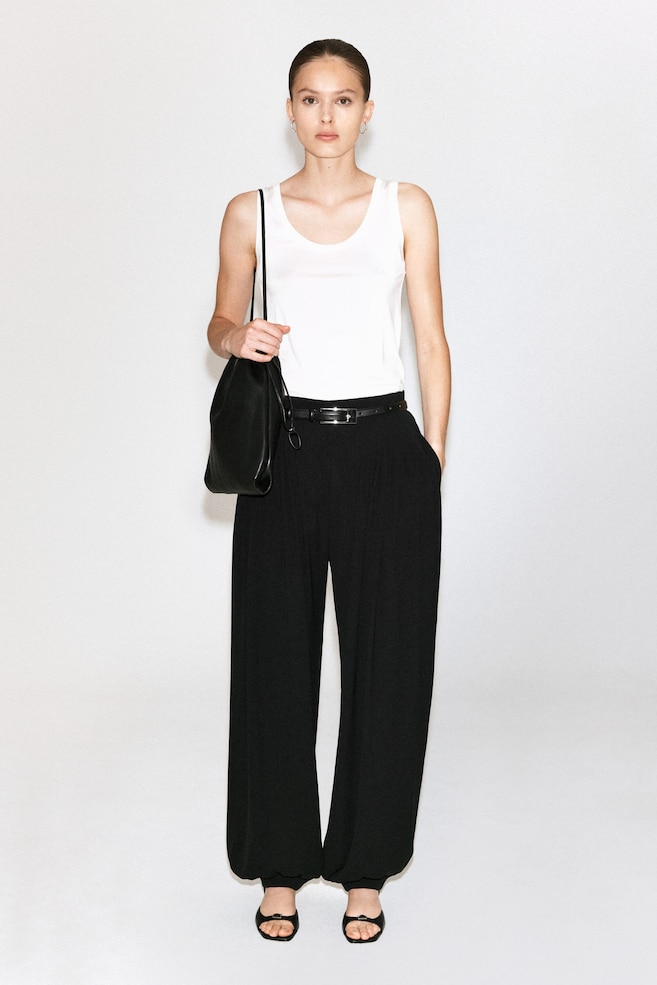 PLEATED CREPE BALLOON PANTS — BLACK
