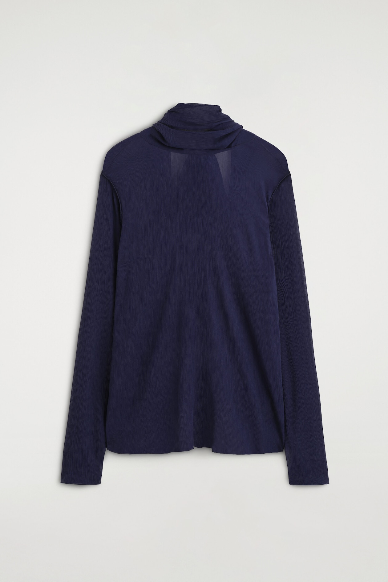 A long-sleeved, dark navy blue crepe top is shown from the front, featuring a high, draped cowl neckline that creates a layered scarf effect. The top showcases a finely textured fabric, a relaxed fit, and straight-cut sleeves.