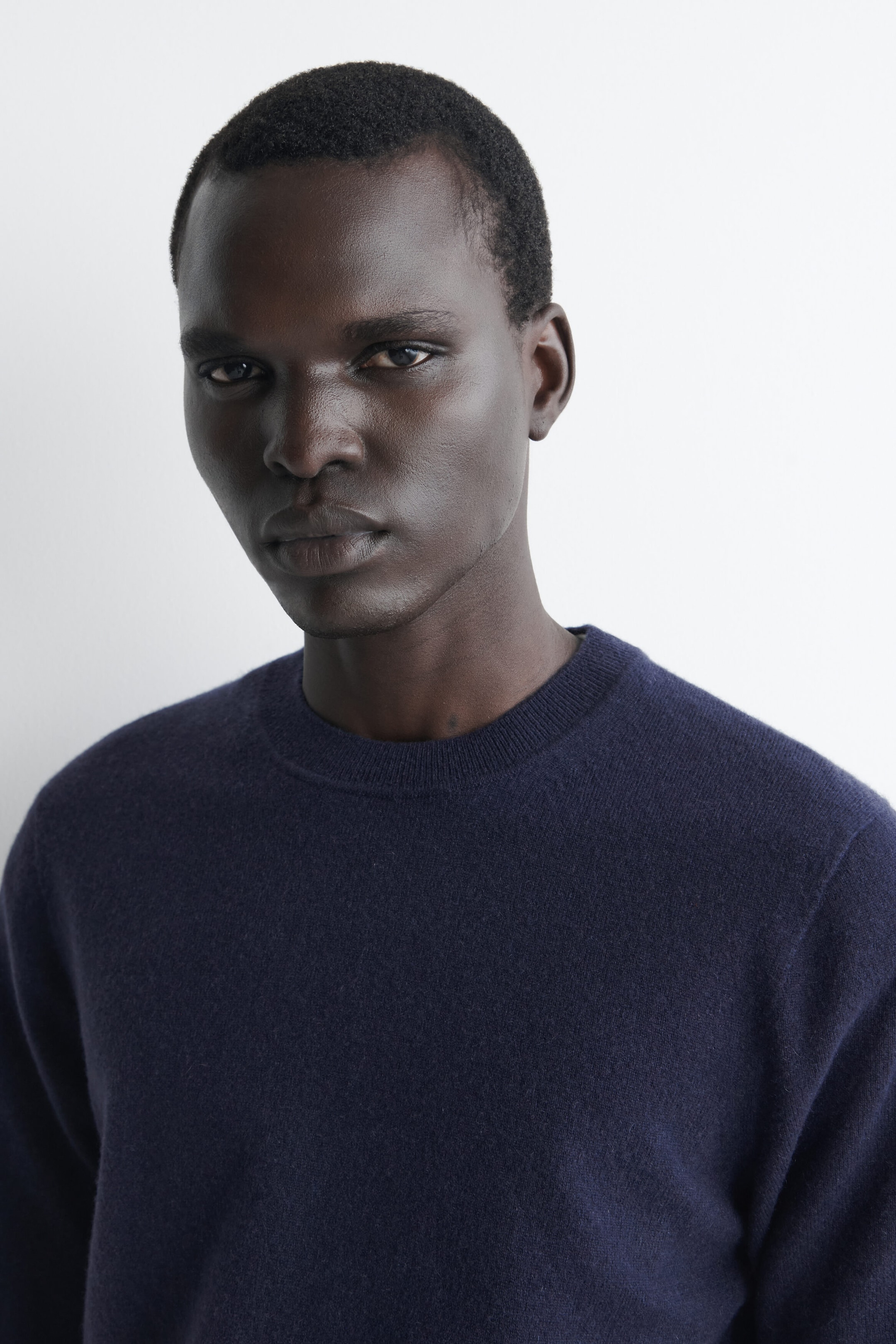 A navy blue cashmere crew neck jumper is shown in a front-facing close-up, highlighting its finely ribbed neckline and soft, fine-knit texture. The garment fits closely around the neck and shoulders to showcase its classic, structured design. A navy blue cashmere crew neck jumper is shown in a front-facing close-up, highlighting its finely ribbed neckline and soft, fine-knit texture. The garment fits closely around the neck and shoulders to showcase its classic, structured design.