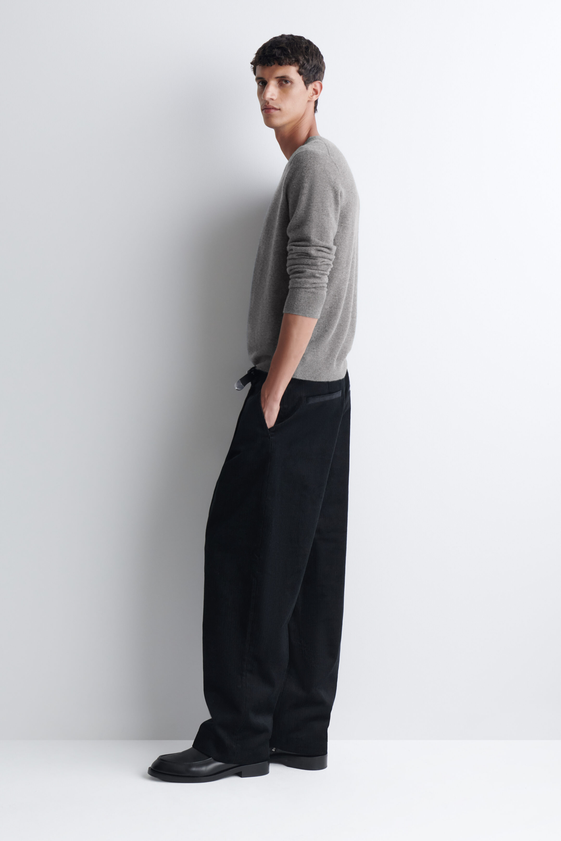 PLEATED RELAXED-FIT TAPERED CORDUROY PANTS - BLACK | COS US