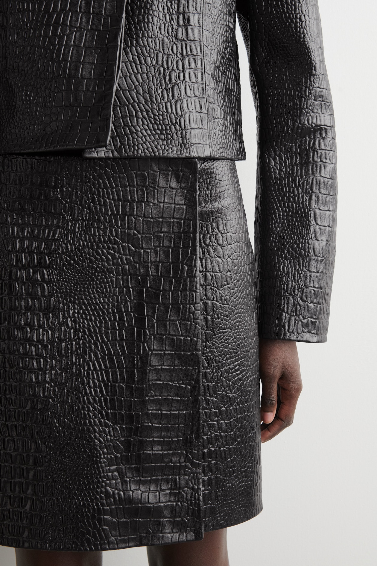 CROC-EFFECT LEATHER MINI WRAP SKIRT — BLACK