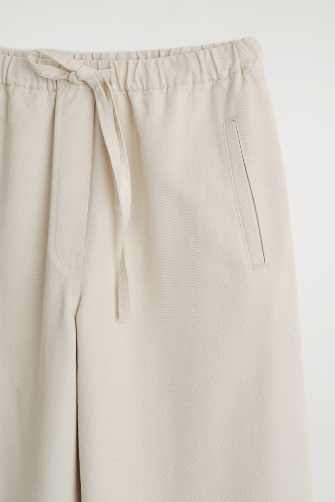 CROPPED DENIM WIDE-LEG TROUSERS — ECRU