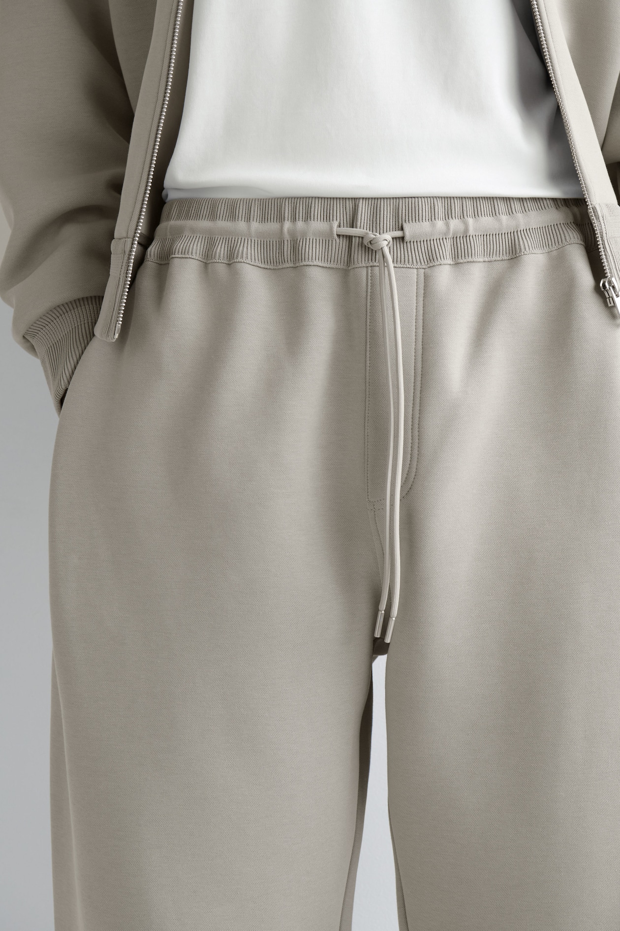 COTTON-PIQUÉ OVERSIZED BARREL-LEG JOGGERS — BEIGE