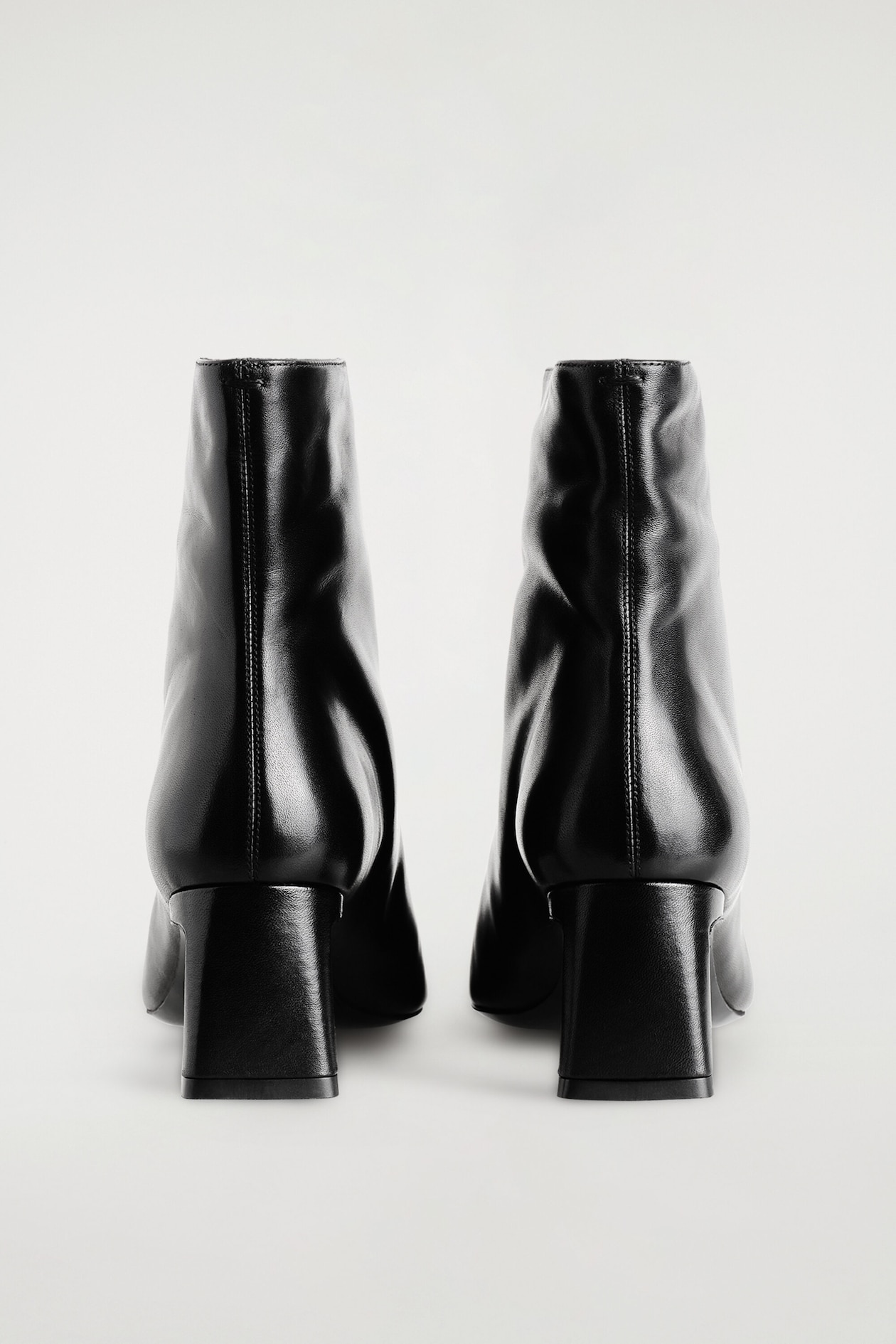 ANGULAR LEATHER HEELED ANKLE BOOTS — BLACK