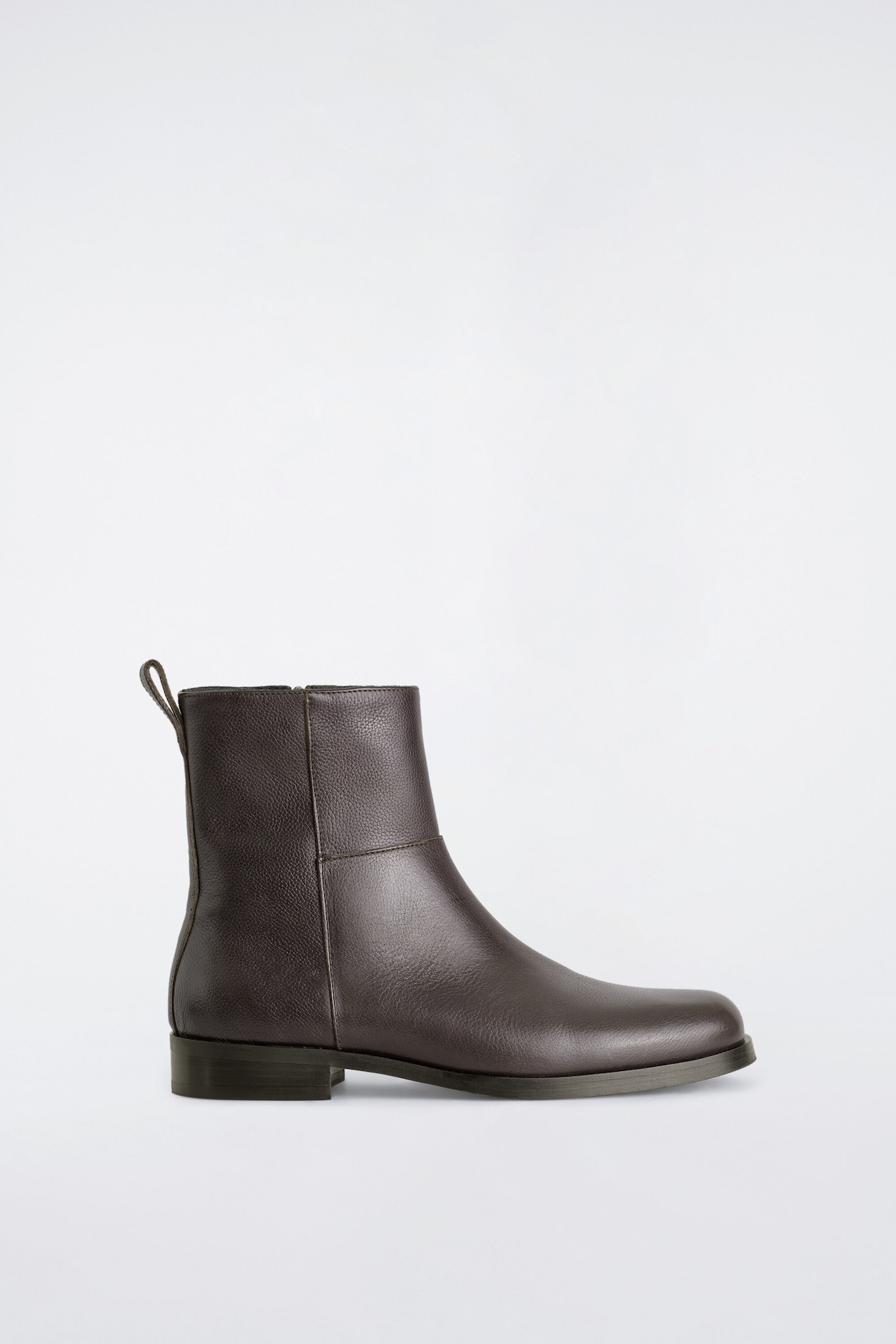 Square-toe leather ankle boots in dark brown are facing right in side profile, displaying a textured pebbled leather finish and a low block heel. The boot features a rear pull tab at the collar and stitched seam detailing across the ankle shaft.