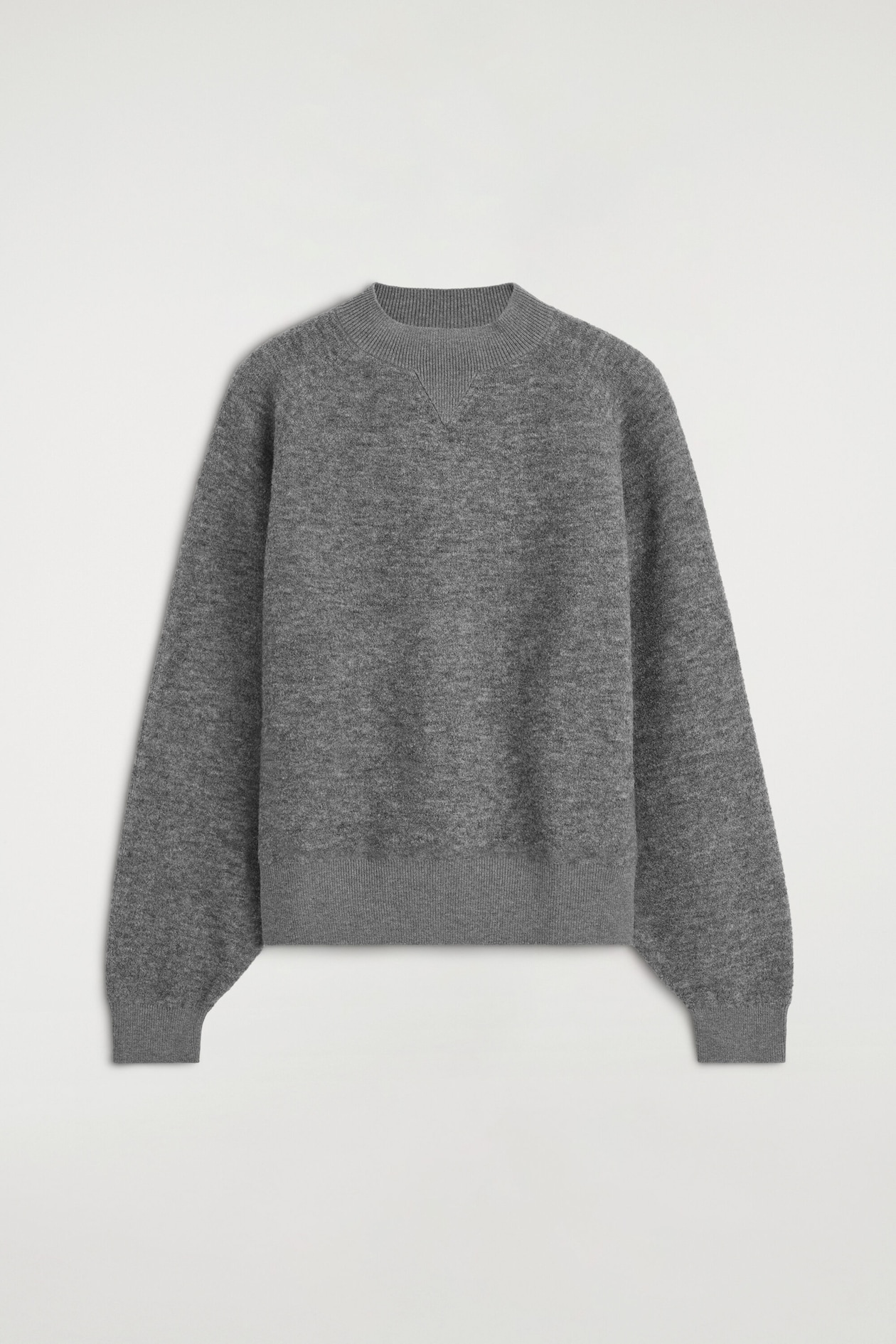 A gray knit sweater is shown from the front, featuring a textured bouclé fabric, a ribbed mock neck with a tonal V-insert, and ribbed details at the cuffs and hem.