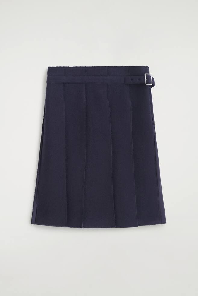 A saia plissada em mistura de lÃ£ com cinto apresenta uma cor azul-marinho escuro, pregas em caixa estruturadas e uma silhueta em linha A, vista de frente. O design integra um cinto no mesmo tecido com fivela retangular em tom prateado na lateral do cÃ³s. - 1
