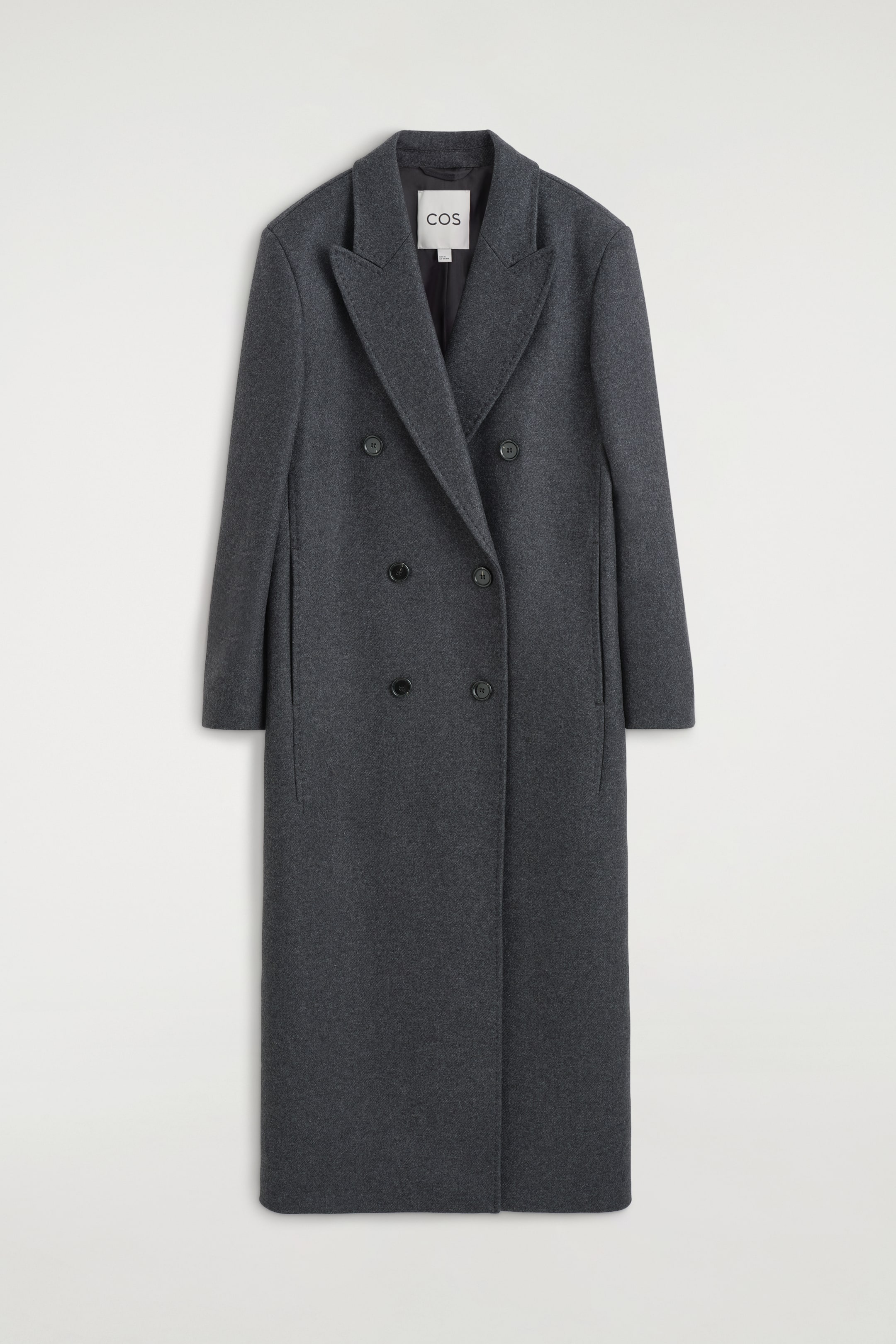 View larger image: A dark grey double-breasted coat is shown from the front, featuring wide notch lapels, four black buttons arranged in two vertical rows, long sleeves, and discreet side pockets.