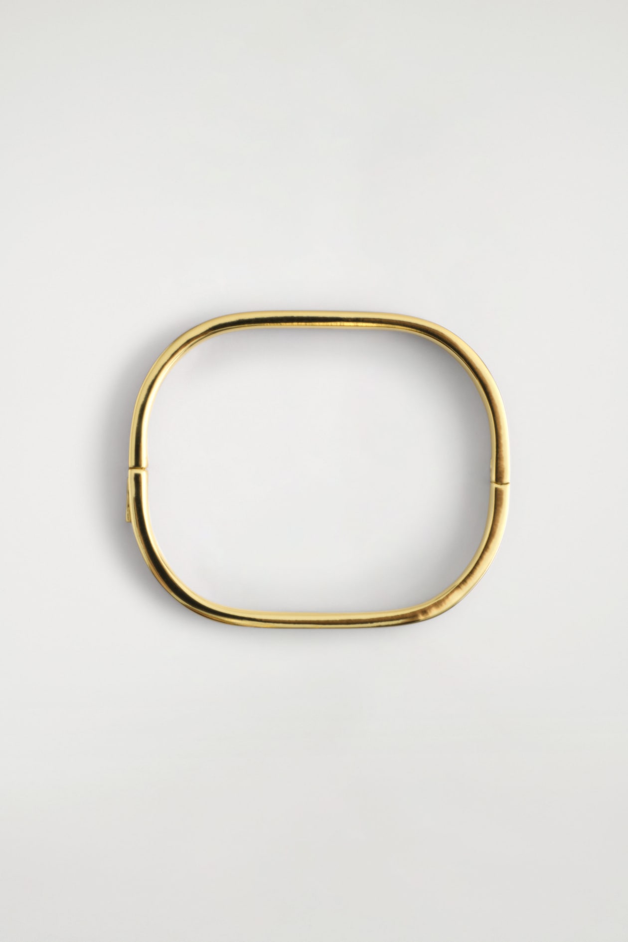 CURVED RECTANGULAR BANGLE — GOLD