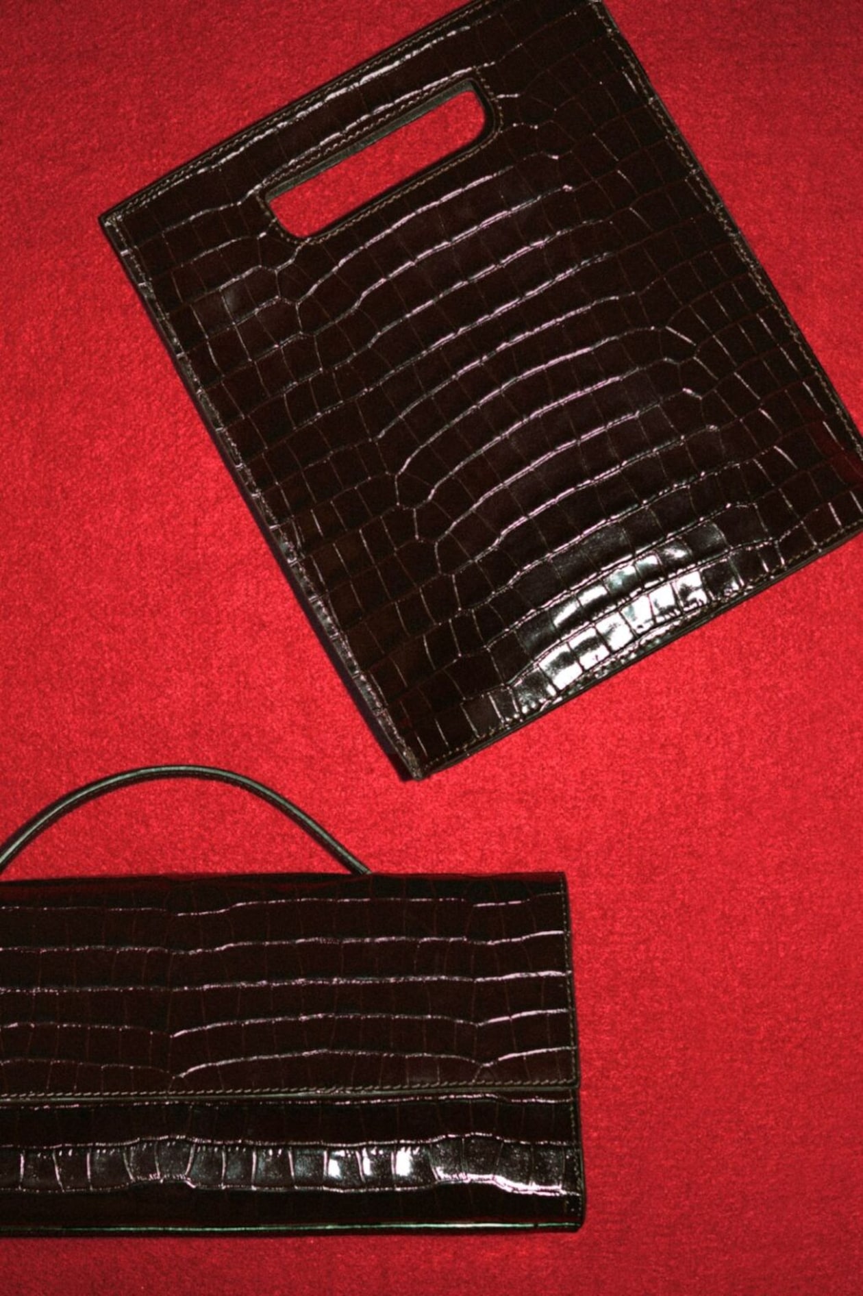 leather croc bags on red background