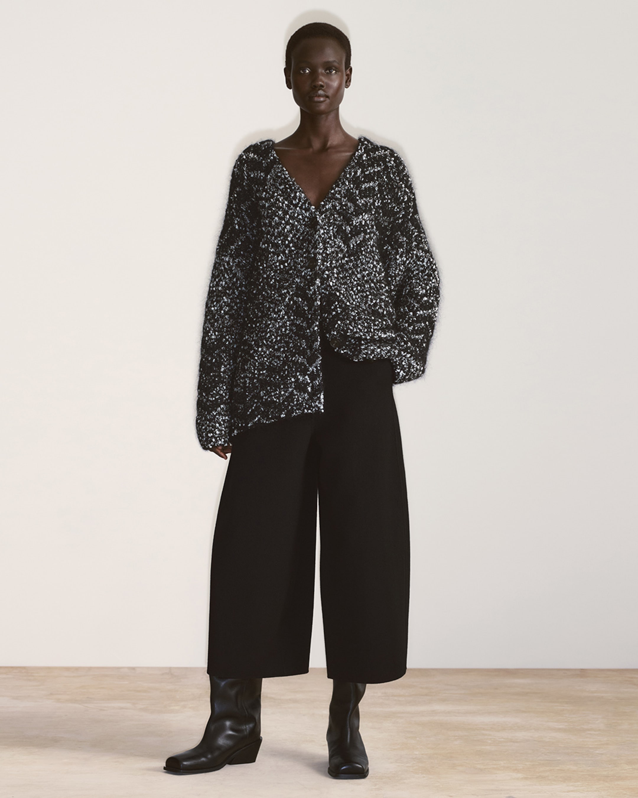 woman in speckled knit cardigan