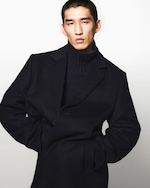 Placeholder for: Model wearing navy knitwear an navy wool coat