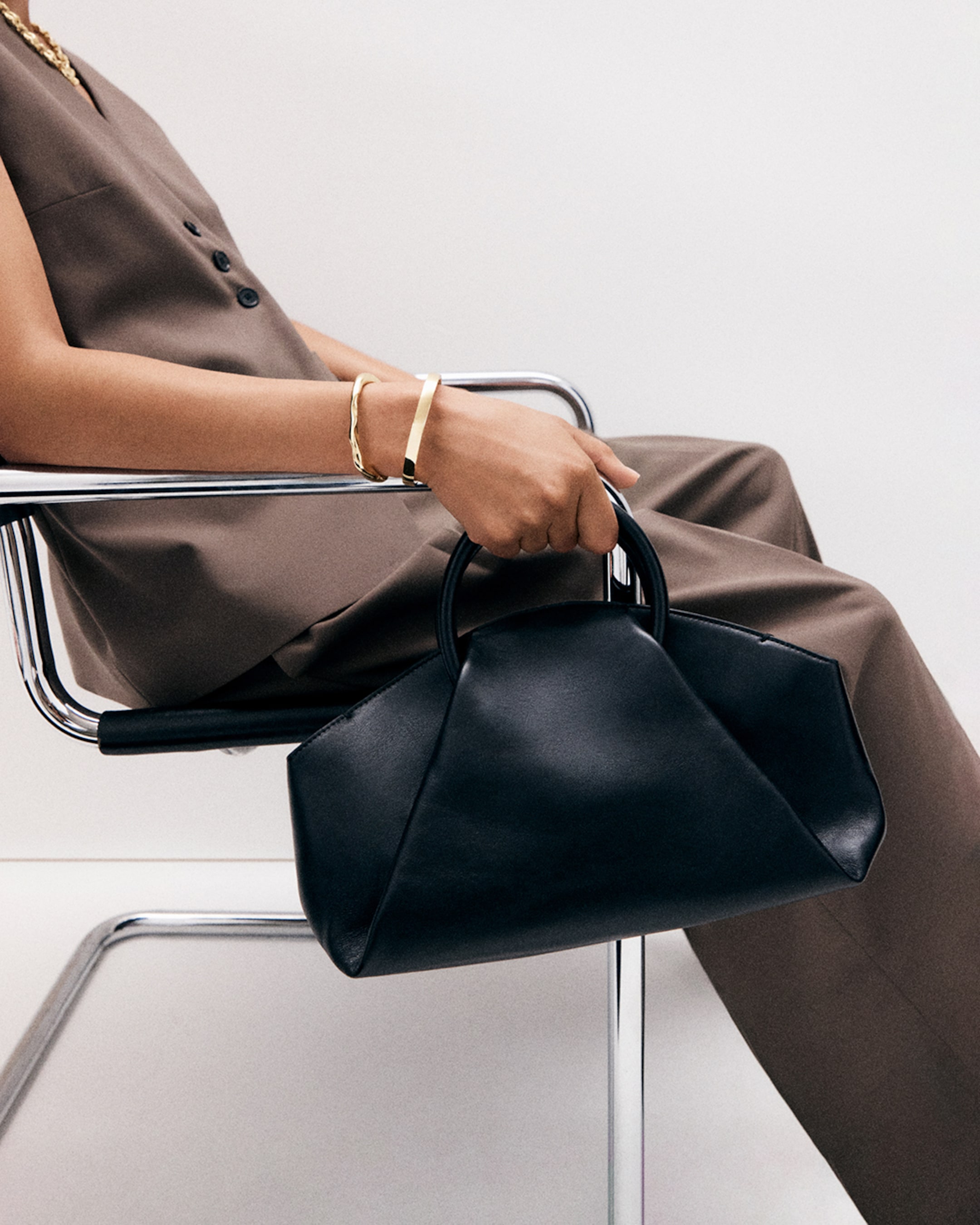 woman with leather fold bag