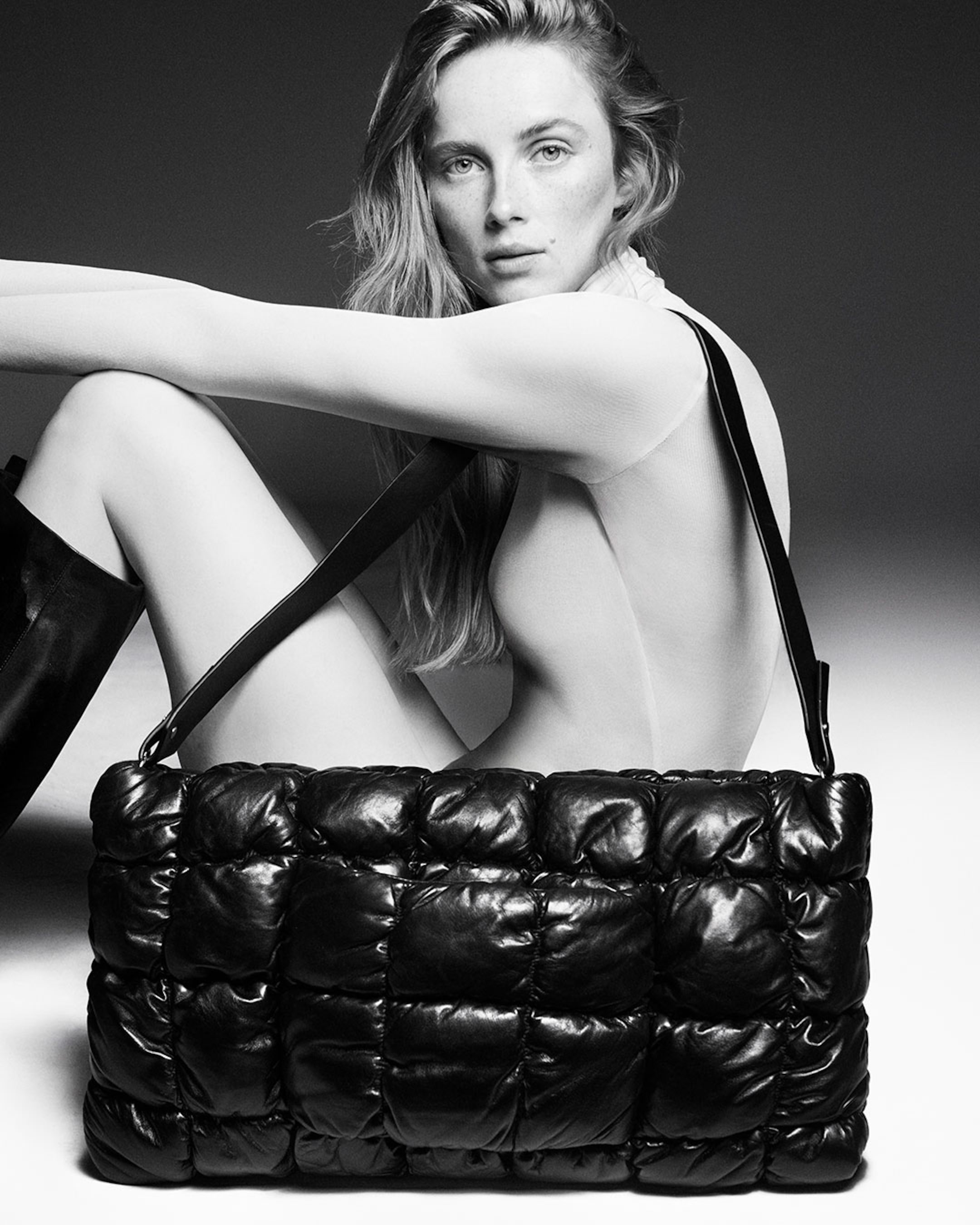 woman with large quilted clutch