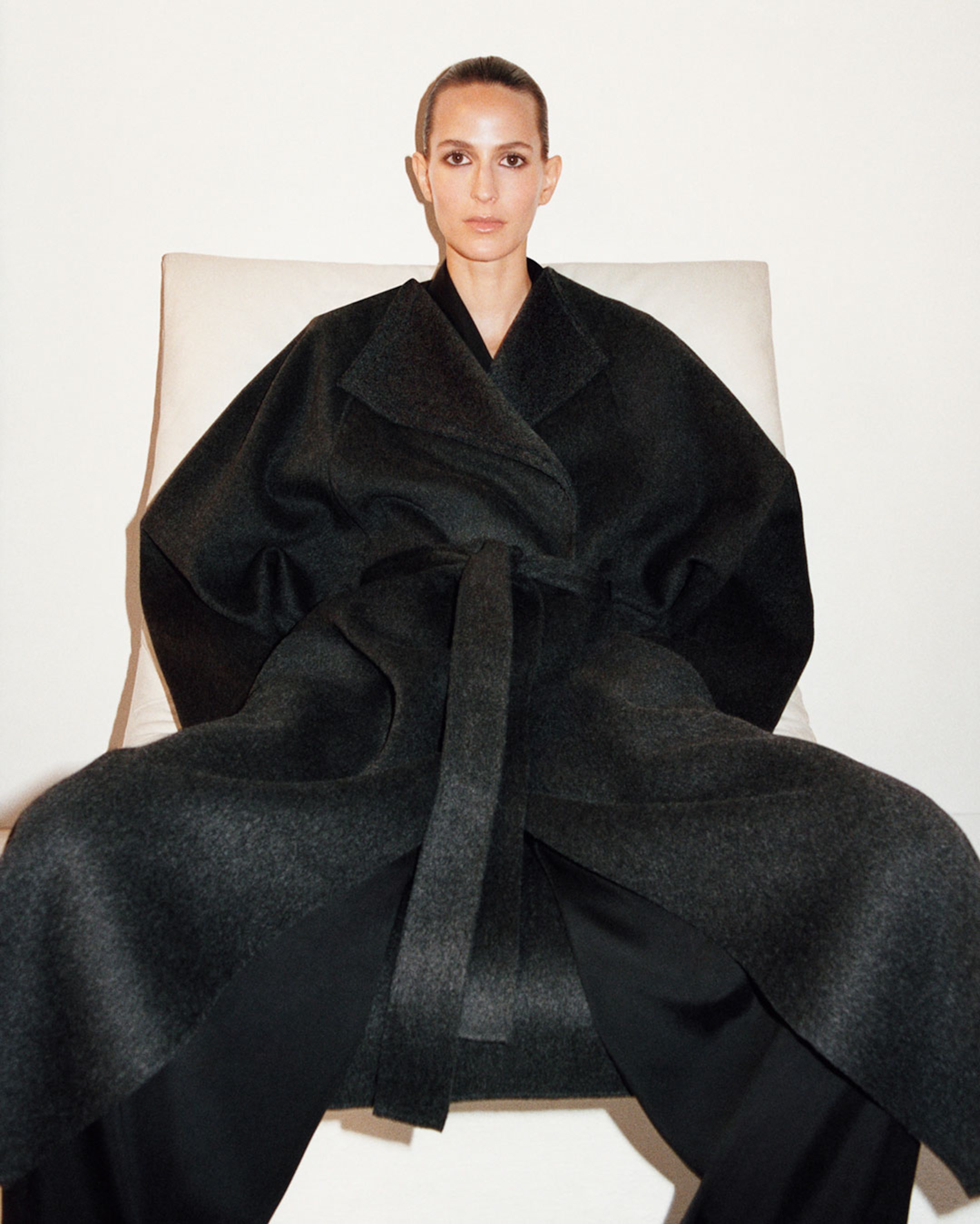 woman sitting wearing coat