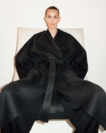 Placeholder for: woman sitting wearing coat