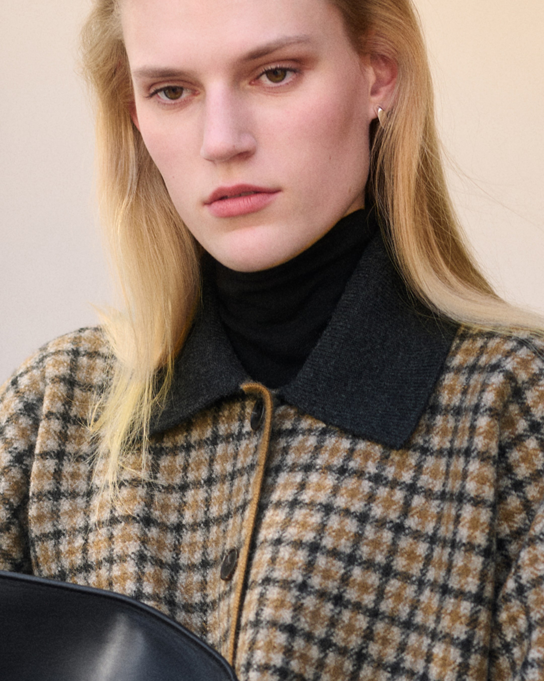 Person wearing brown jacket