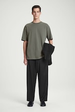 Placeholder for: Man in oversized green top