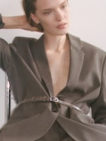 Placeholder for: Women in suit and snake belt