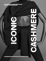 Placeholder for: Model in a dark cashmere outfit with bold text "Iconic Cashmere" and Spanish text promoting exquisite softness.