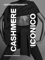 Placeholder for: A person wearing a black cashmere sweater with "CASHMERE ICONICO" written in bold white text. Italian text indicating luxurious softness.