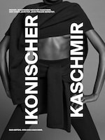 Placeholder for: Monochrome fashion ad featuring a person wearing layered cashmere clothing with bold German text promoting softness and joy.