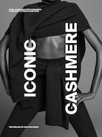 Placeholder for: Model posed in black cashmere clothing, featuring the words "ICONIC CASHMERE" and promoting the softness of COS cashmere fabric.