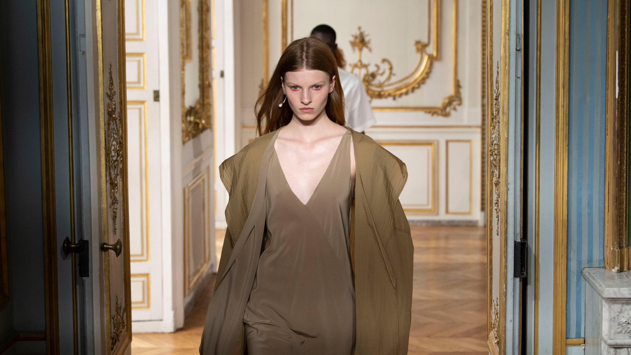 Person wears Atelier beige coat and dress