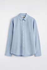 Placeholder for: Light blue long-sleeve button-up shirt with a classic collar, displayed against a white background.