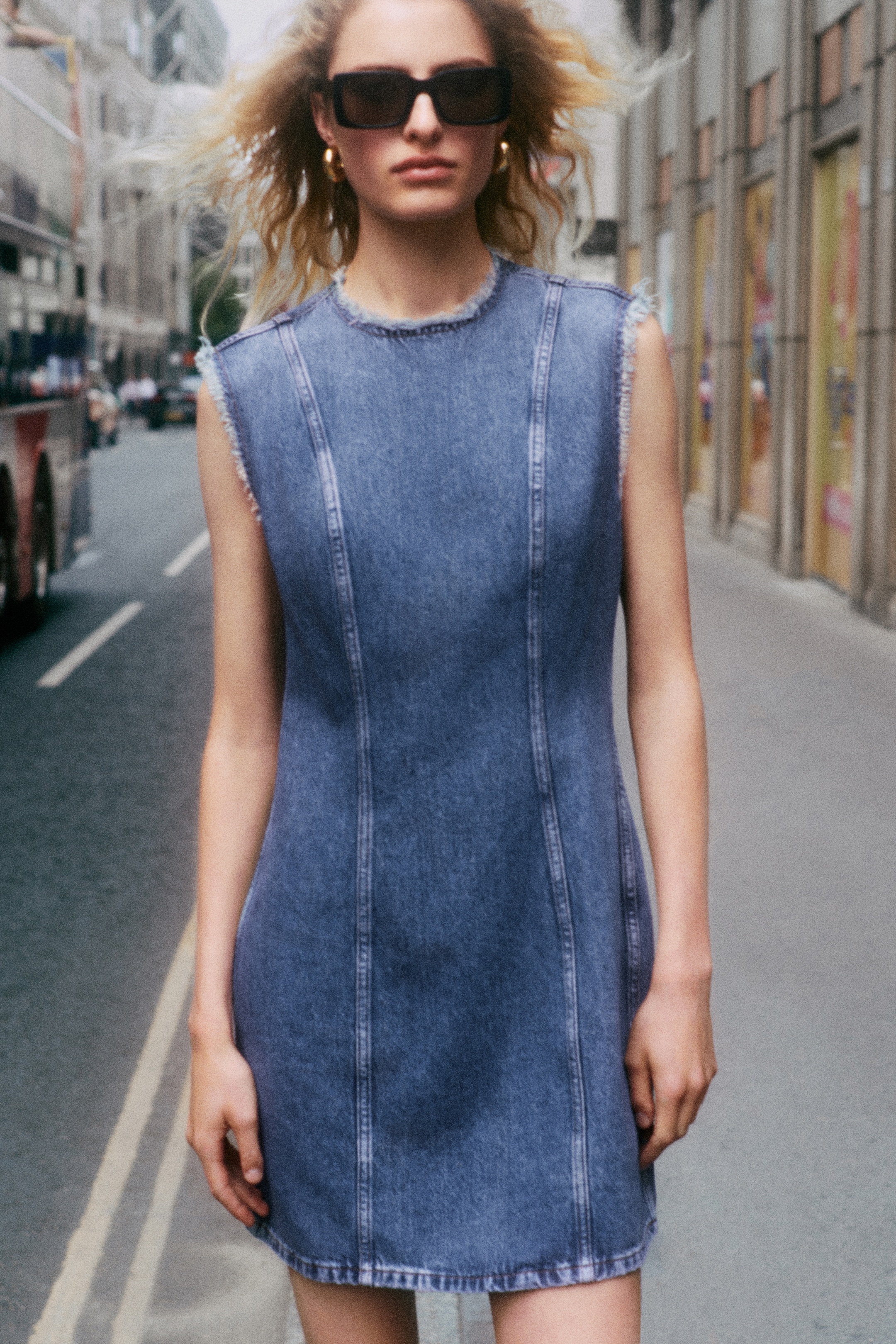 Person standing wearing denim dress