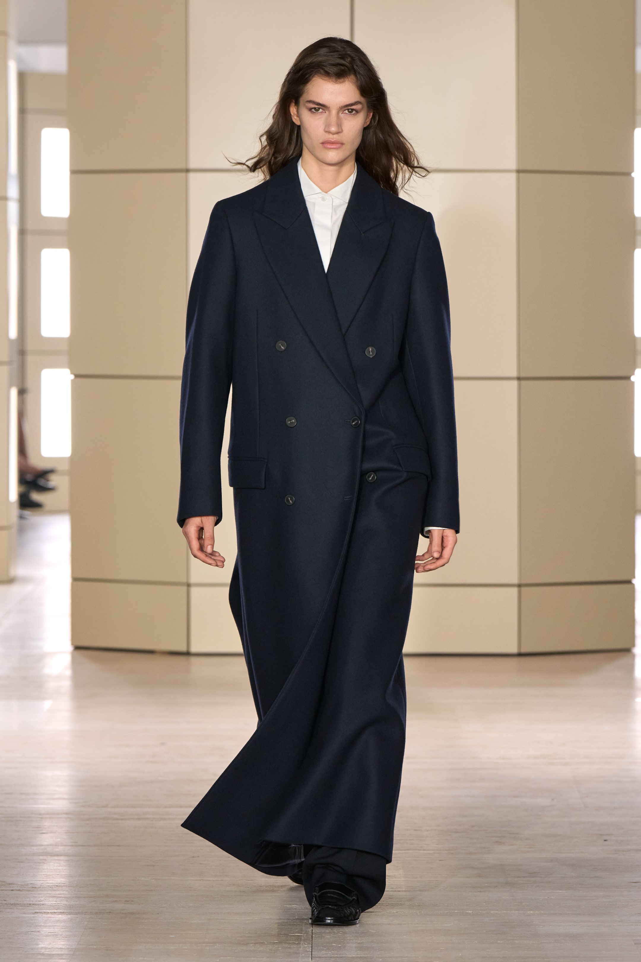 Person walking on a runway wearing black