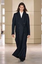 Placeholder for: Person walking on a runway wearing black