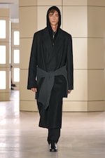 Placeholder for: Person walking on a runway wearing a black wool coat