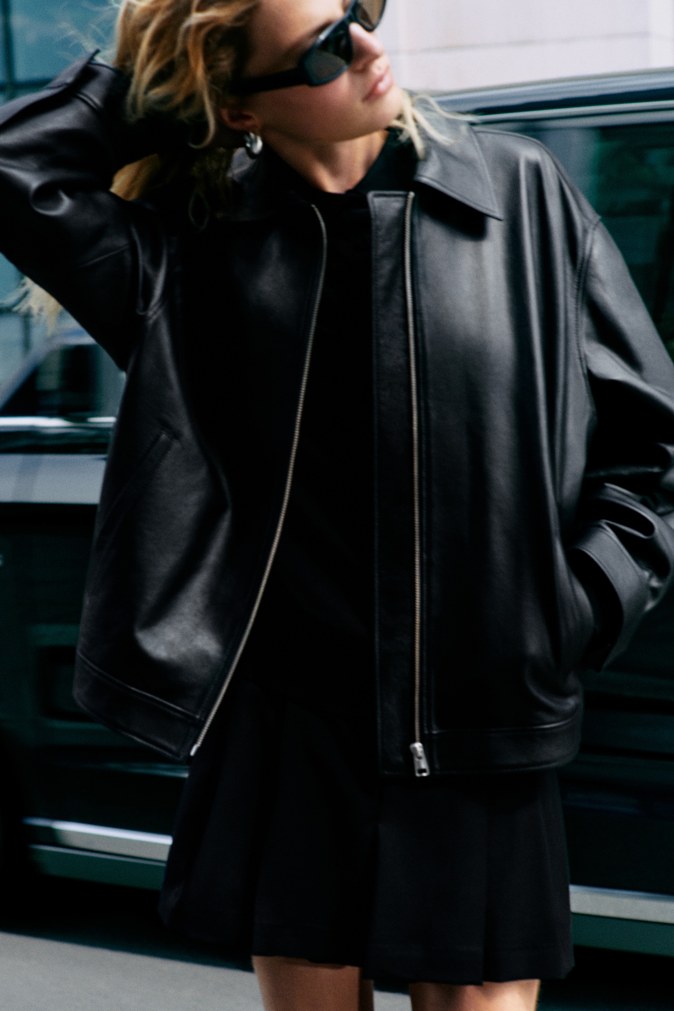 Women wearing a black leather jacket and black skirt