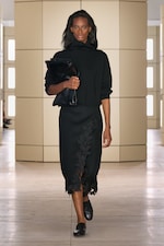 Placeholder for: Person walking on a runway wearing black