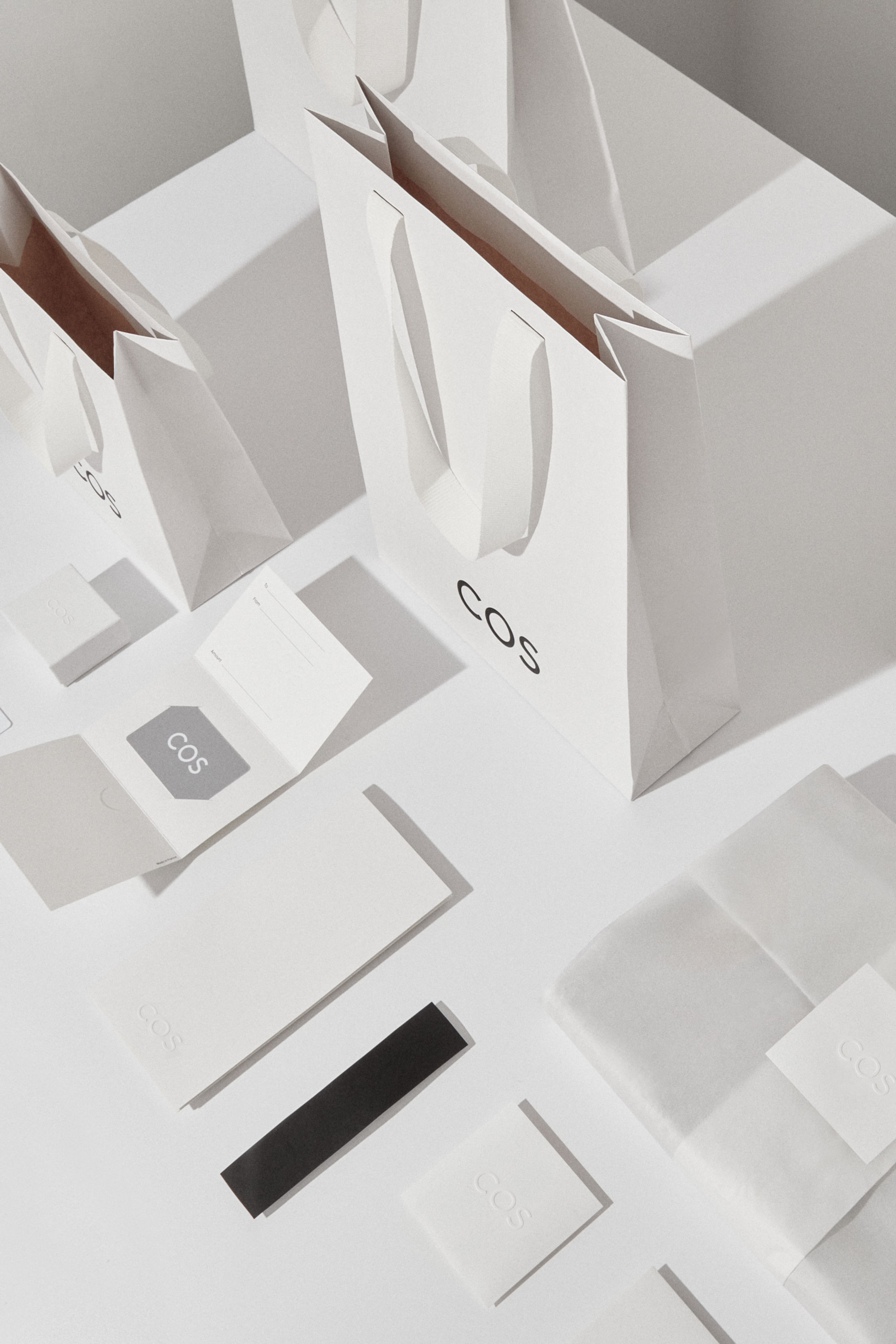 White COS shopping bag and gift card